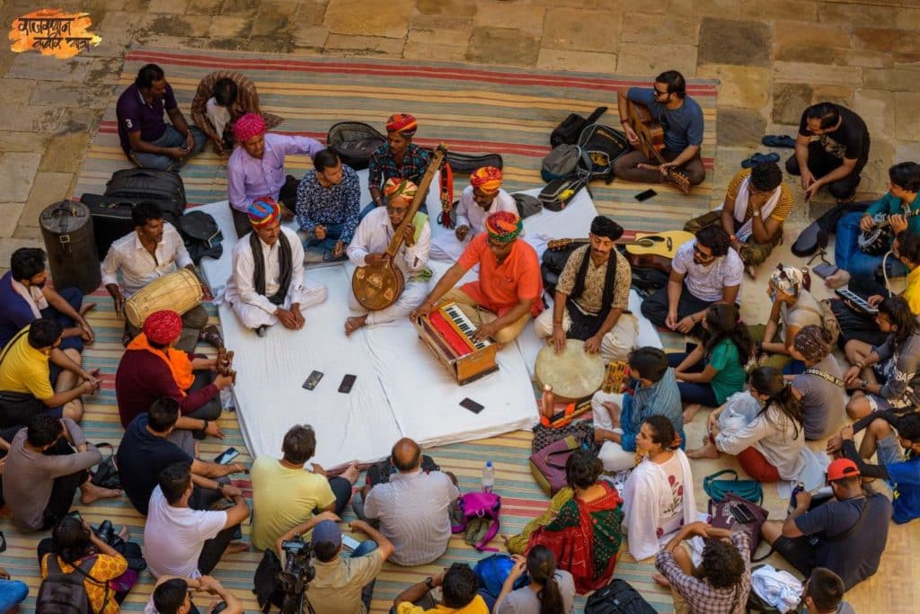 The photograph features Mahesharamji, leading the Morning Satsang at Sikar in the 2019 Rajasthan Kabir Yatra. Photo: Anchit Natha